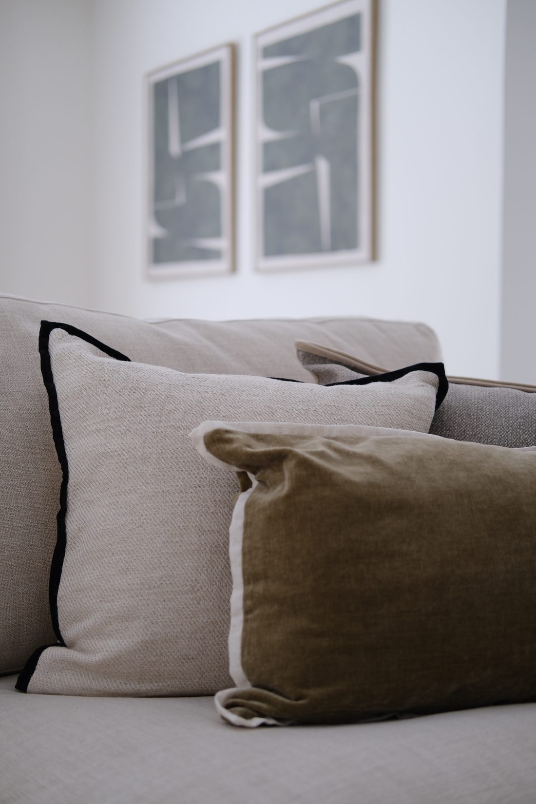 Cushion layering — moss velvet and flax linen with black velvet piping
